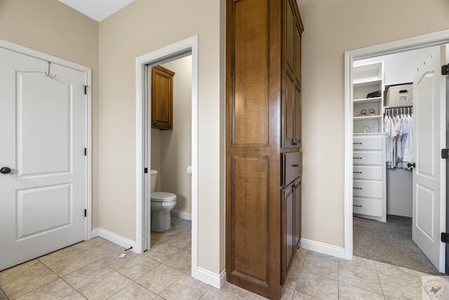 bathroom with tile patterned floors and toilet