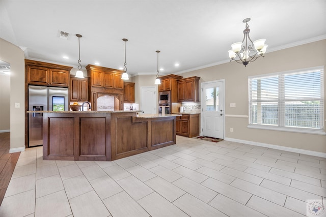 kitchen featuring hanging light fixtures, a large island, appliances with stainless steel finishes, and crown molding