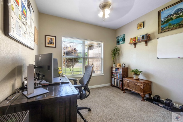 carpeted office space featuring ceiling fan