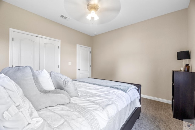 carpeted bedroom featuring ceiling fan and a closet