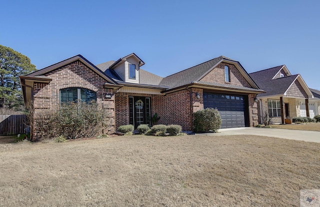 french country inspired facade with driveway, brick siding, an attached garage, and fence