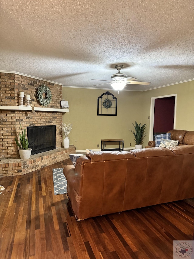 living room with a fireplace, a textured ceiling, dark hardwood / wood-style floors, and ceiling fan