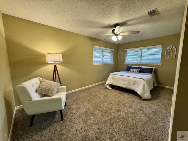 bedroom featuring carpet, a textured ceiling, and ceiling fan