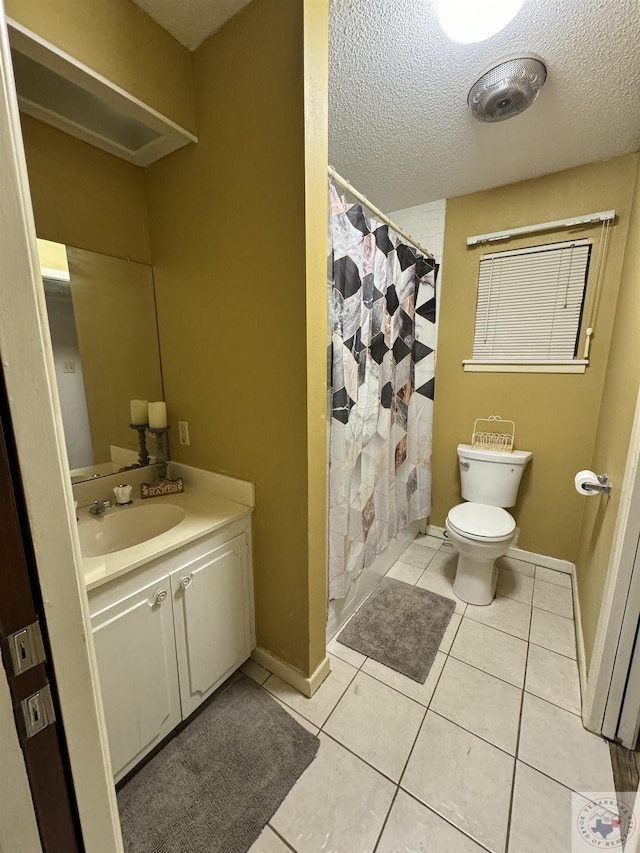 bathroom featuring tile patterned flooring, a shower with curtain, toilet, a textured ceiling, and vanity