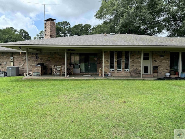 back of house with a patio, central air condition unit, and a yard