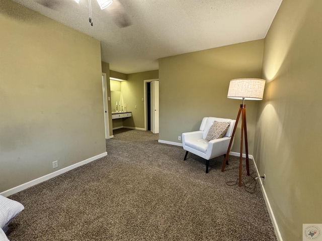 living area with a textured ceiling and carpet flooring