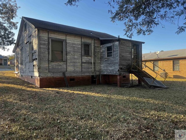 rear view of house with a lawn