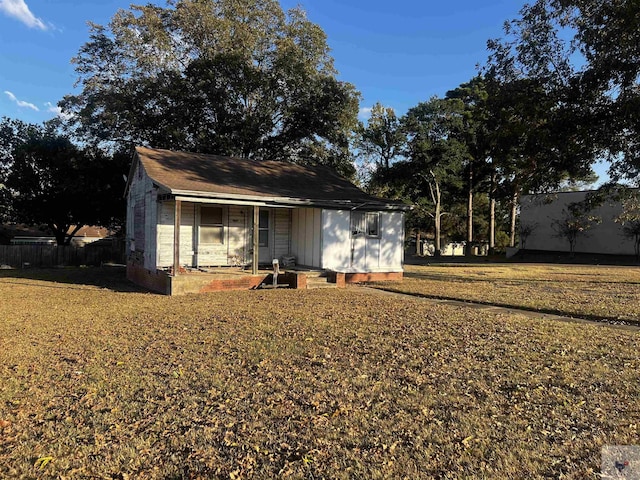 exterior space featuring a front yard and an outbuilding