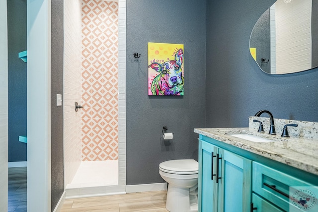 bathroom featuring a shower, wood-type flooring, toilet, and vanity