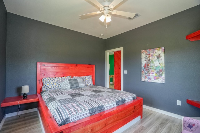 bedroom with wood-type flooring and ceiling fan