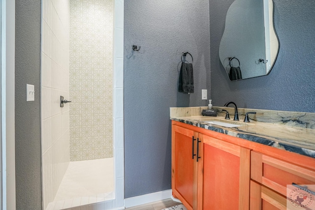 bathroom with a shower and vanity