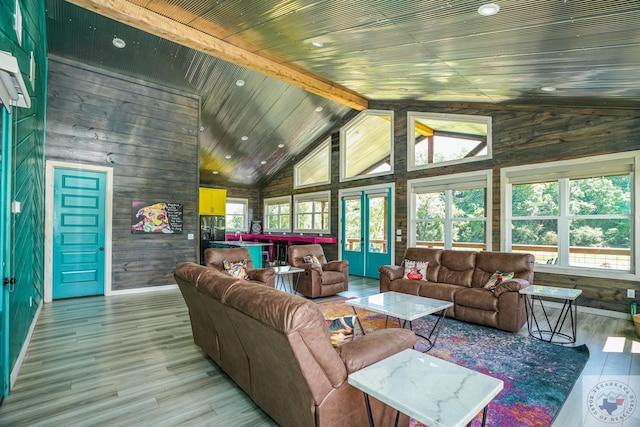 living room with light hardwood / wood-style floors, wooden ceiling, wooden walls, french doors, and lofted ceiling with beams