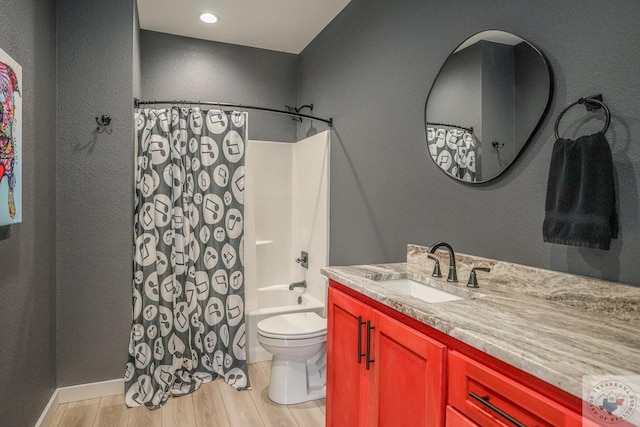 full bathroom with wood-type flooring, shower / bath combo with shower curtain, toilet, and vanity