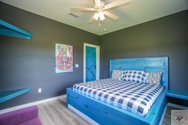 bedroom with ceiling fan and hardwood / wood-style flooring