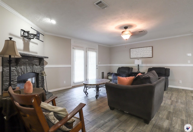 1966 George Thomas Rd, Texarkana, TX 75501 - living area featuring visible vents, baseboards, wood finish floors, ornamental molding, and a fireplace
