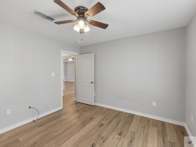 spare room with visible vents, light wood-style flooring, and baseboards