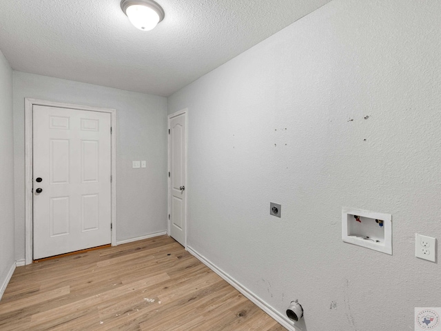 laundry room with laundry area, light wood finished floors, a textured ceiling, hookup for an electric dryer, and washer hookup