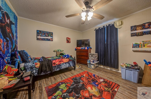 bedroom featuring ornamental molding, ceiling fan, hardwood / wood-style floors, and a textured ceiling