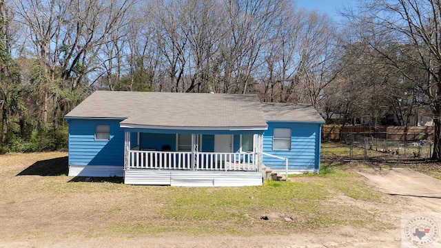 bungalow-style house with covered porch and a front lawn