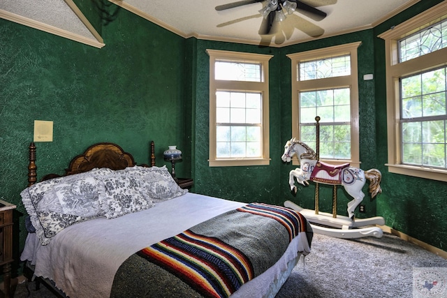 carpeted bedroom featuring ceiling fan, multiple windows, and crown molding