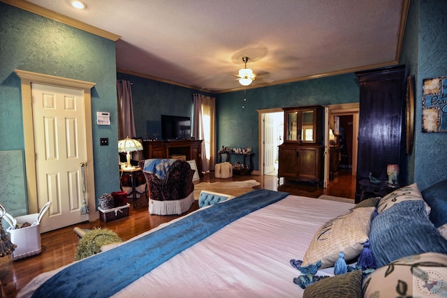 bedroom with ceiling fan, dark hardwood / wood-style flooring, and crown molding