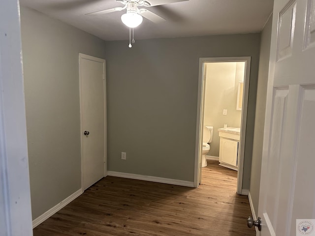 unfurnished bedroom featuring hardwood / wood-style flooring, connected bathroom, and ceiling fan