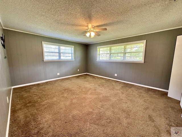 empty room with ceiling fan, dark carpet, and a textured ceiling