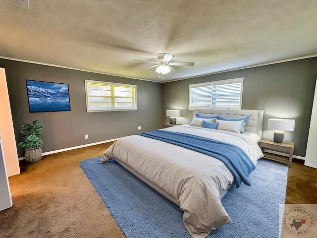 bedroom featuring ornamental molding, carpet, wooden walls, and ceiling fan