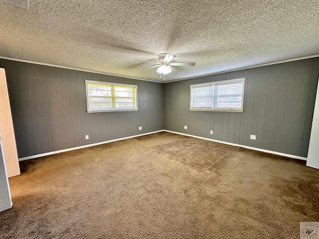 empty room with a textured ceiling, ceiling fan, and carpet flooring