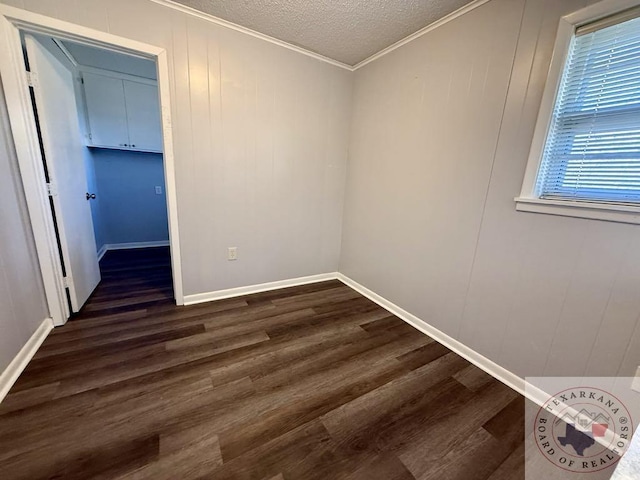 unfurnished room with crown molding, dark hardwood / wood-style floors, and a textured ceiling