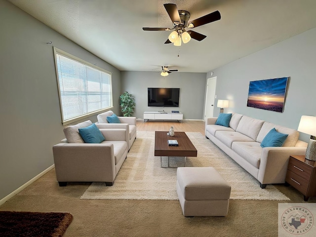 carpeted living room with ceiling fan