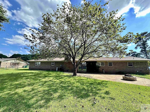 view of yard featuring a patio and an outdoor fire pit