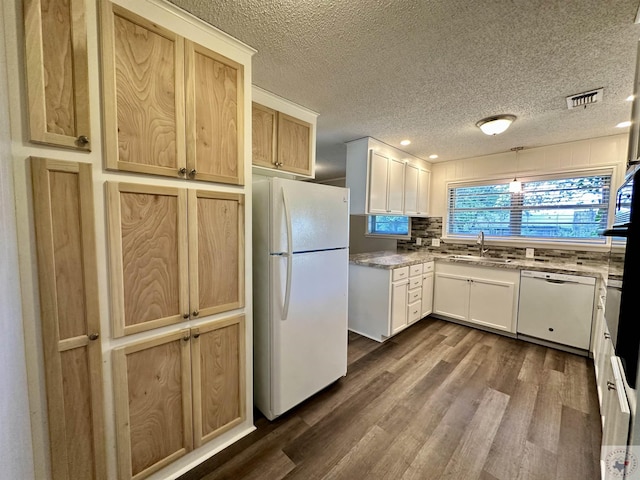 kitchen with dark wood-type flooring, sink, a textured ceiling, white appliances, and white cabinets