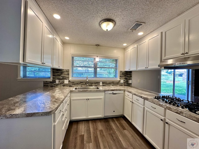 kitchen featuring decorative light fixtures, dishwasher, sink, white cabinets, and dark wood-type flooring