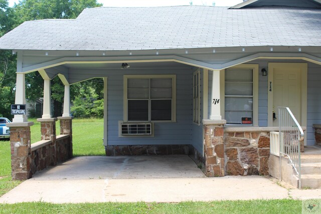 view of exterior entry featuring a carport