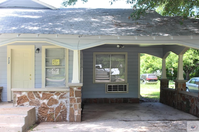 view of exterior entry featuring covered porch