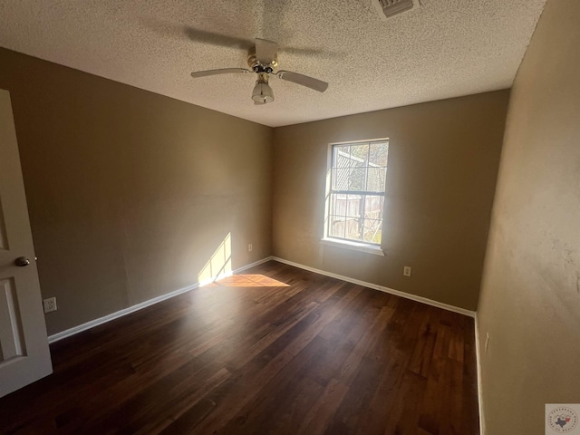 empty room with dark wood-type flooring, a textured ceiling, and ceiling fan