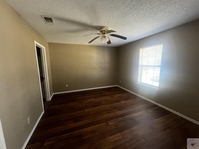 spare room featuring a textured ceiling, ceiling fan, and dark hardwood / wood-style flooring