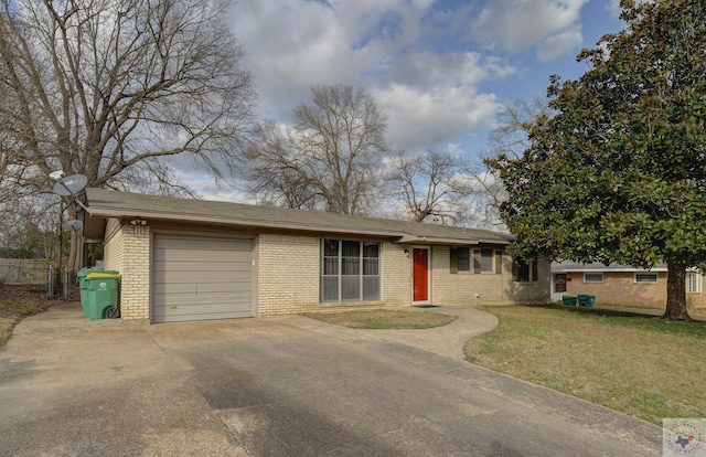 ranch-style house featuring a garage and a front yard