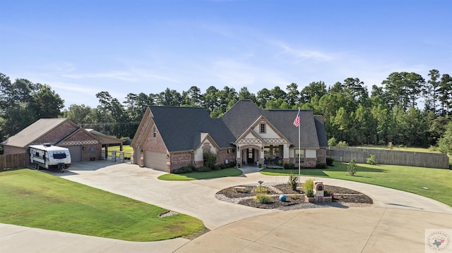 view of front of property featuring a front yard and a garage