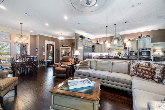 living room with a chandelier, ornamental molding, and dark wood-type flooring