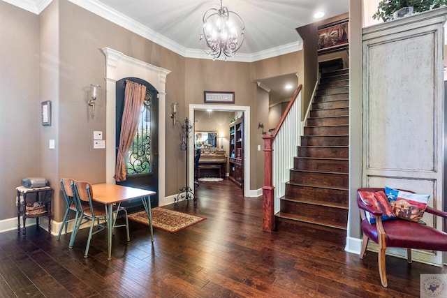 entrance foyer with a notable chandelier, crown molding, and dark hardwood / wood-style floors