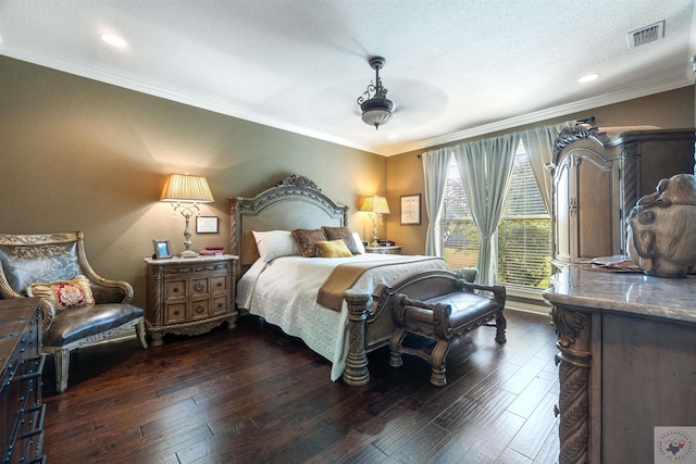 bedroom with ceiling fan, a textured ceiling, dark hardwood / wood-style flooring, and crown molding