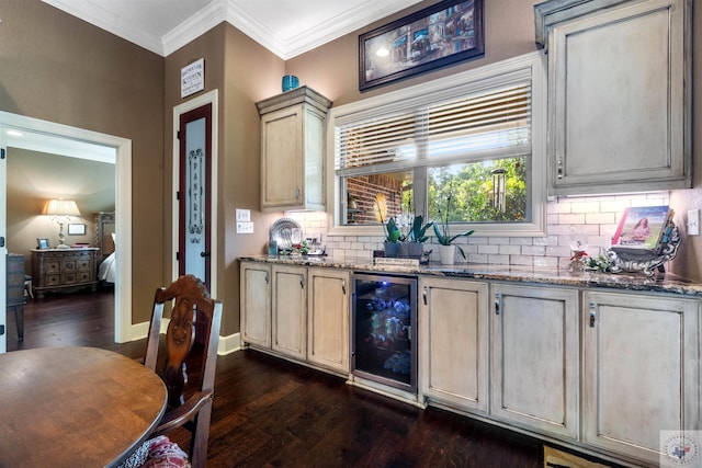 kitchen featuring cream cabinets, stone counters, ornamental molding, dark hardwood / wood-style flooring, and beverage cooler