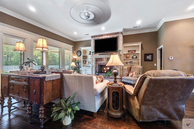 living room featuring built in shelves, ornamental molding, a fireplace, and dark hardwood / wood-style flooring