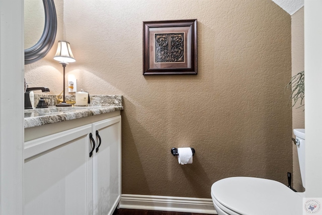 bathroom with toilet and vanity