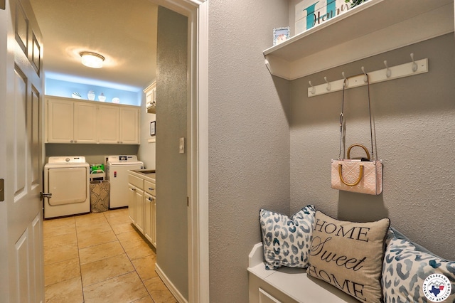 7215 N Richland Dr, Texarkana, TX 75503 - washroom with separate washer and dryer, cabinet space, a textured wall, and light tile patterned floors