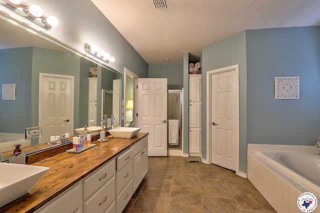 7215 N Richland Dr, Texarkana, TX 75503 - bathroom featuring a bath, a sink, a shower stall, and double vanity