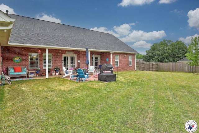 7215 N Richland Dr, Texarkana, TX 75503 - rear view of house featuring a fenced backyard, a shingled roof, french doors, a lawn, and brick siding