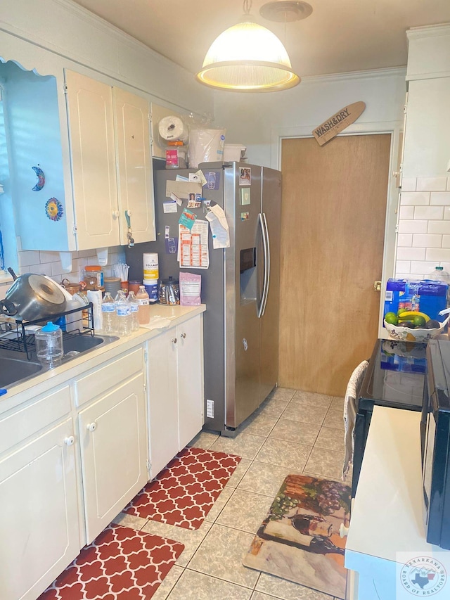 kitchen featuring white cabinets, decorative backsplash, stainless steel fridge with ice dispenser, and light tile patterned floors